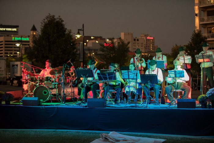 Polka band performing on stage at night.