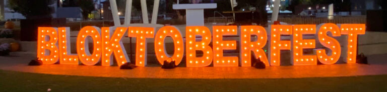 Giant lighted letters sit on the ground, spelling BLOKTOBERFEST.