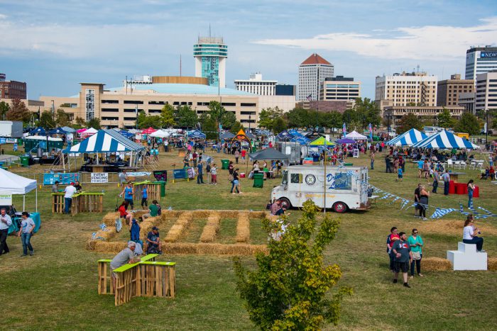 Wide shot of Bloktoberfest event with beer trucks, games and food vendors. Downtown Wichita is visible in the background.