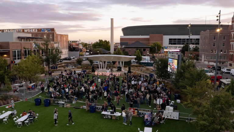 Aerial photo of the 2024 ICT Bloktoberfest Beer Fest event. There is a stage, tables with beer vendors and lots of participants.