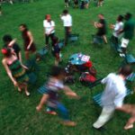 Adults playing musical chairs.
