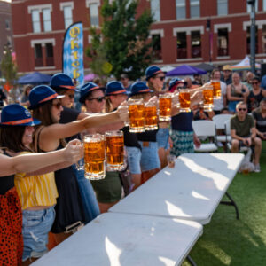 A group participates in a beer stein hoist.